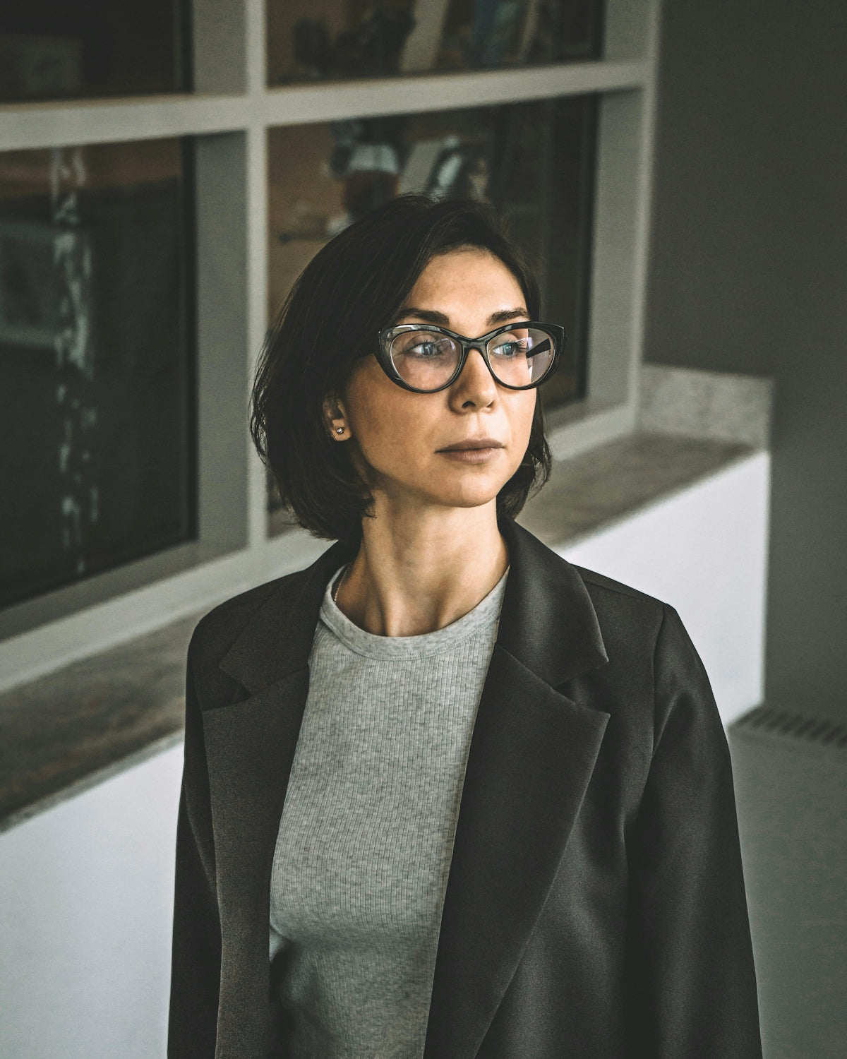 woman in black blazer wearing eyeglasses