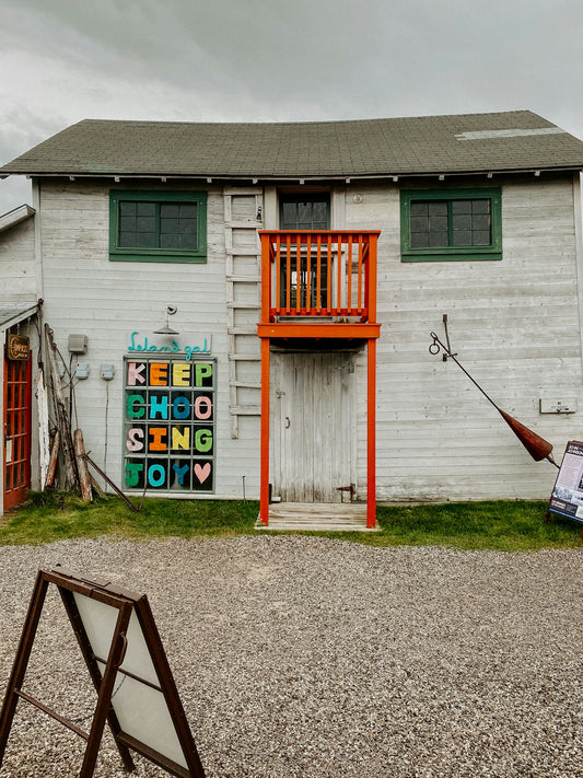 a white building with a sign that says keep school going today