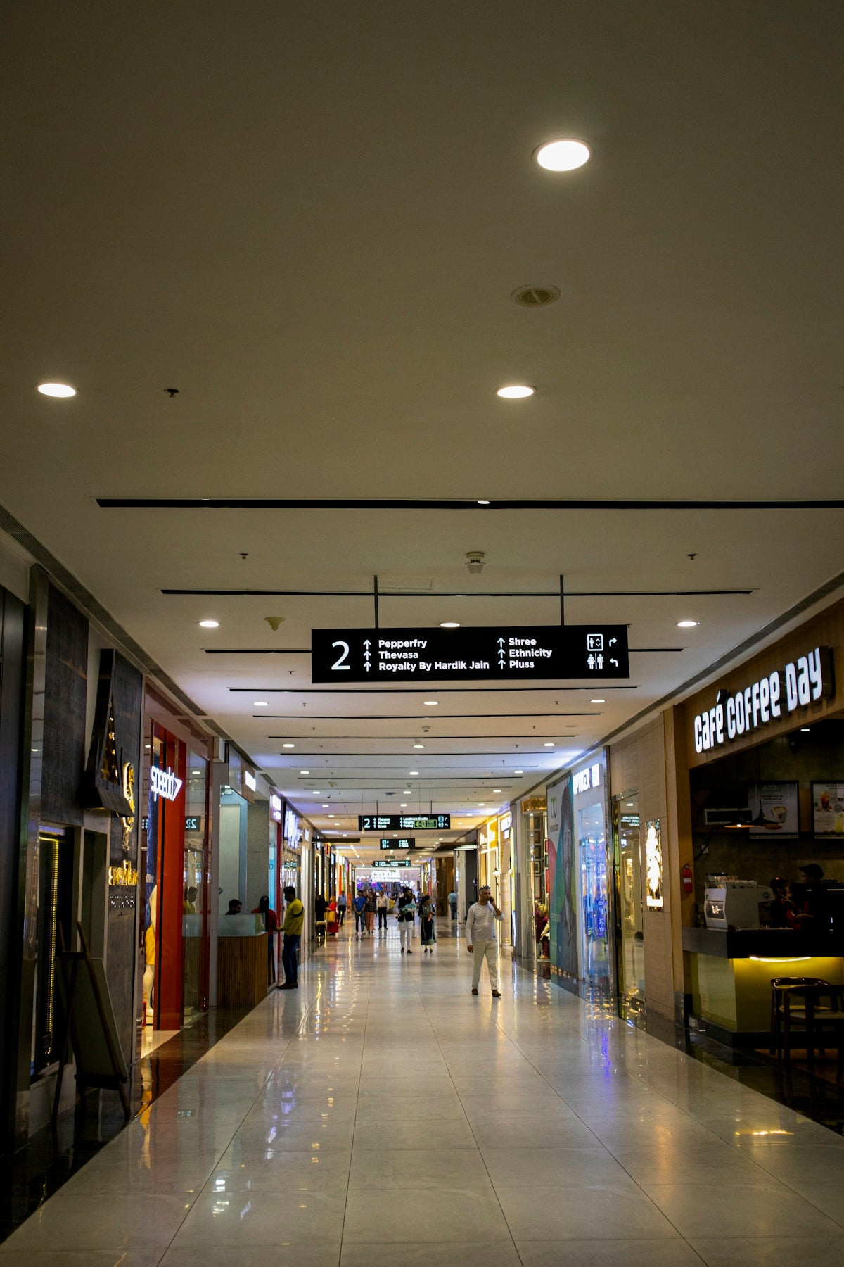 a couple of people that are walking down a hallway