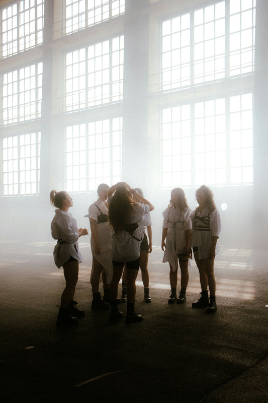 a group of people standing in front of a window