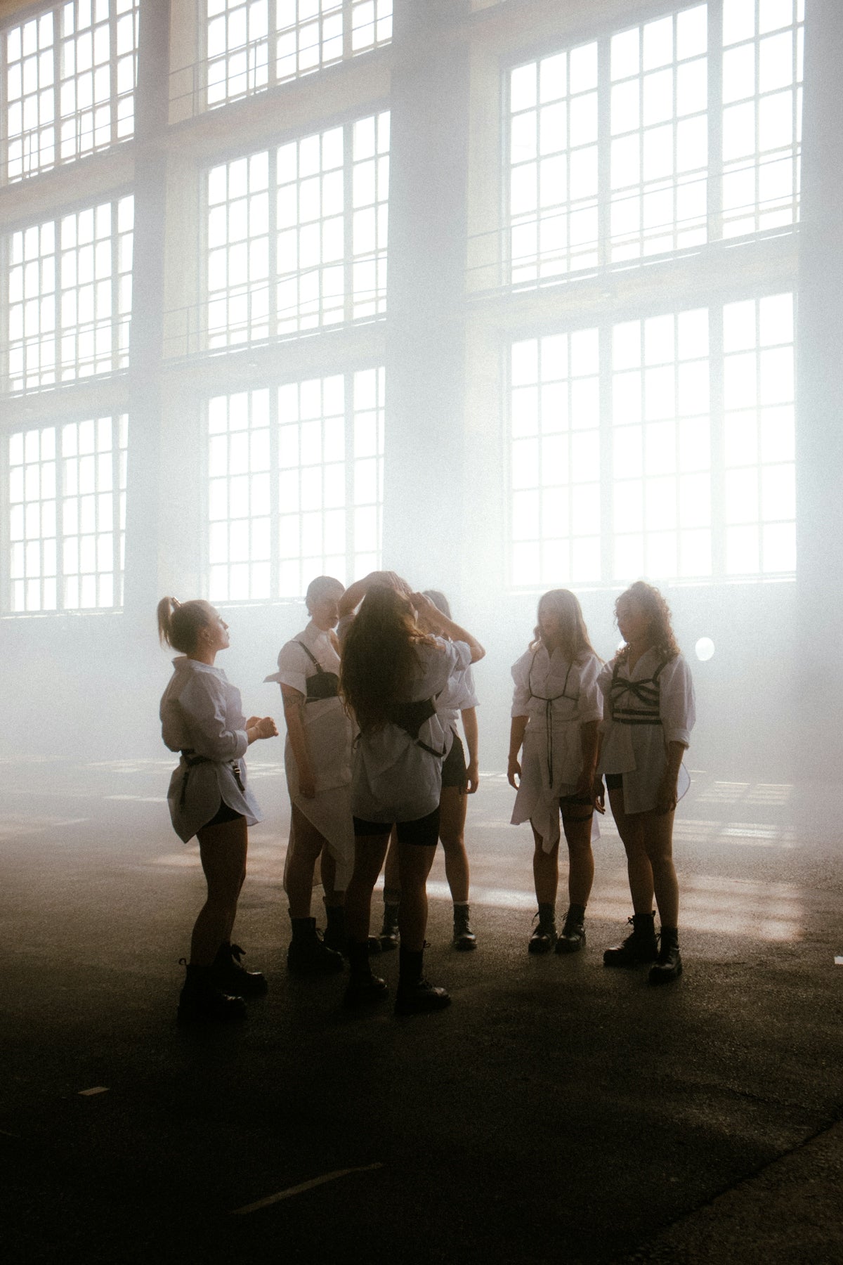 a group of people standing in front of a window