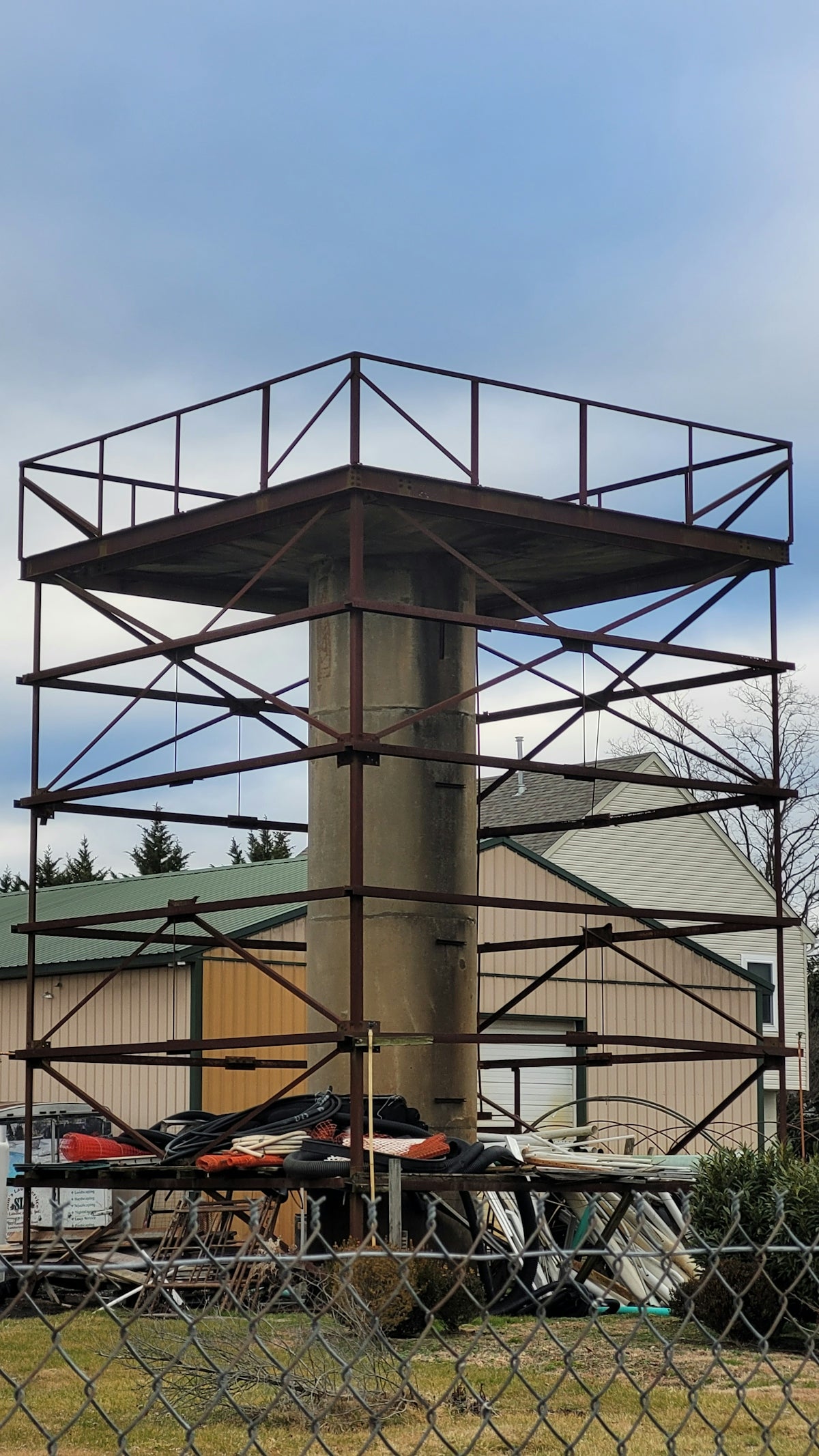a tall metal tower sitting next to a building