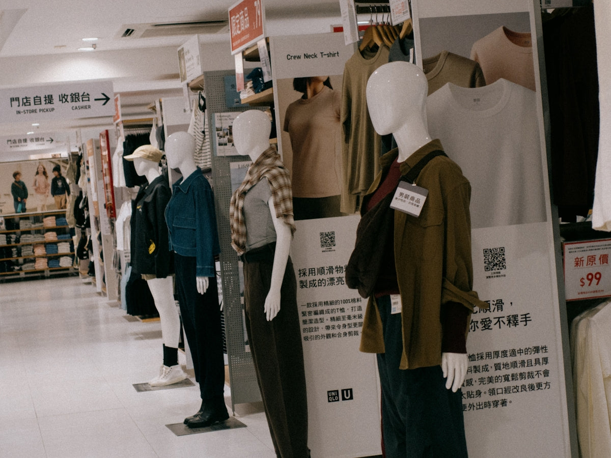 A group of mannequins are standing in a store